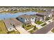 Aerial view of a residential street, showcasing homes with manicured lawns and lake views at 33645 Elm Hill Br, Wesley Chapel, FL 33545
