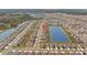 Aerial view of homes in a community with a lake, showcasing the neighborhood's layout at 33645 Elm Hill Br, Wesley Chapel, FL 33545