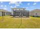 Expansive backyard featuring a screened lanai, perfect for outdoor entertaining and relaxation at 33645 Elm Hill Br, Wesley Chapel, FL 33545