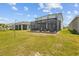 Expansive backyard with a screened patio provides a private outdoor retreat for relaxation and entertainment at 33645 Elm Hill Br, Wesley Chapel, FL 33545