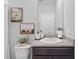 Modern bathroom featuring a granite countertop, vanity mirror, sink, and white toilet at 33645 Elm Hill Br, Wesley Chapel, FL 33545