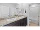 Bathroom featuring double sinks, granite countertop, vanity, and access to the toilet and shower at 33645 Elm Hill Br, Wesley Chapel, FL 33545