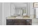 Neutral bathroom featuring granite counters, modern mirror and vanity at 33645 Elm Hill Br, Wesley Chapel, FL 33545