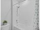 Clean, white bathroom with a tub and shower combination with neutral tile at 33645 Elm Hill Br, Wesley Chapel, FL 33545