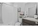 Bathroom with white shower and shower curtain, vanity mirror, sink, and white toilet at 33645 Elm Hill Br, Wesley Chapel, FL 33545