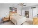 Bedroom with modern decor featuring a ceiling fan, carpet, and windows overlooking the neighborhood at 33645 Elm Hill Br, Wesley Chapel, FL 33545