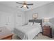 Cozy bedroom with ceiling fan, with a framed drawing and nightstand with lamp at 33645 Elm Hill Br, Wesley Chapel, FL 33545