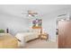 Bedroom with modern decor featuring a ceiling fan, carpet, and windows overlooking the neighborhood at 33645 Elm Hill Br, Wesley Chapel, FL 33545