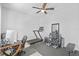 Multi-purpose room with ceiling fan, desk, and exercise equipment offers a flexible space for work and fitness at 33645 Elm Hill Br, Wesley Chapel, FL 33545