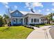 Exterior view of the clubhouse with blue and white siding and a paved walkway at 33645 Elm Hill Br, Wesley Chapel, FL 33545