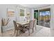 Bright dining area with sliding glass doors leading to a screened patio with views of the pond at 33645 Elm Hill Br, Wesley Chapel, FL 33545