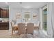 Dining room with modern table, natural light, and an adjacent view of the kitchen at 33645 Elm Hill Br, Wesley Chapel, FL 33545