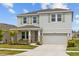 Charming two-story home with a well-manicured lawn and a two-car garage at 33645 Elm Hill Br, Wesley Chapel, FL 33545