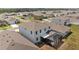 Aerial perspective of a home, highlighting the screened-in lanai in the backyard at 33645 Elm Hill Br, Wesley Chapel, FL 33545