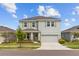 Charming two-story home with a well-manicured lawn and a two-car garage at 33645 Elm Hill Br, Wesley Chapel, FL 33545