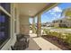 Inviting front porch with seating that overlooks the beautifully landscaped front yard at 33645 Elm Hill Br, Wesley Chapel, FL 33545