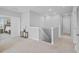 Upstairs hallway features an orchid, a small table, a spindled railing, and neutral colors at 33645 Elm Hill Br, Wesley Chapel, FL 33545