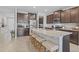 Kitchen with granite countertops, stainless steel appliances, and a large kitchen island with seating at 33645 Elm Hill Br, Wesley Chapel, FL 33545