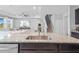 Spacious kitchen island with granite countertop, stainless steel sink and kitchen view to the living room at 33645 Elm Hill Br, Wesley Chapel, FL 33545