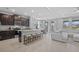 Open concept kitchen with a granite island, stainless steel appliances, and dark wood cabinetry at 33645 Elm Hill Br, Wesley Chapel, FL 33545