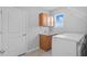 Functional laundry room with washer, dryer, storage cabinet, and sink offers convenience and efficiency at 33645 Elm Hill Br, Wesley Chapel, FL 33545