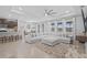 Spacious living room featuring a large sectional sofa, tile floors, and plenty of natural light at 33645 Elm Hill Br, Wesley Chapel, FL 33545