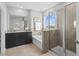Bright bathroom featuring a glass shower, soaking tub, and granite countertop vanity at 33645 Elm Hill Br, Wesley Chapel, FL 33545