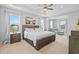 Bright main bedroom with tray ceilings, plush carpet, and ensuite sitting area at 33645 Elm Hill Br, Wesley Chapel, FL 33545