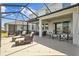 Spacious screened-in patio offers an inviting outdoor living area with plenty of seating and views of the manicured backyard at 33645 Elm Hill Br, Wesley Chapel, FL 33545