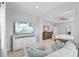 Comfortable sitting room with large TV, neutral carpet and modern lighting at 33645 Elm Hill Br, Wesley Chapel, FL 33545