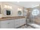Modern bathroom featuring double sinks, white cabinets, granite countertop, and walk-in shower at 3710 W Tacon St, Tampa, FL 33629