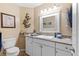 Neutral tones throughout bathroom with white vanity, turtle art, and light fixtures at 3710 W Tacon St, Tampa, FL 33629