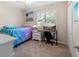 Comfortable bedroom with ample natural light, carpet, and beach themed art at 3710 W Tacon St, Tampa, FL 33629
