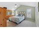 Inviting bedroom with vaulted ceiling, neutral walls, ceiling fan, and large windows with custom blinds at 3710 W Tacon St, Tampa, FL 33629