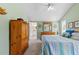 Comfortable bedroom with light green walls, wood furniture, and bright natural light at 3710 W Tacon St, Tampa, FL 33629