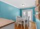 Dining area featuring wood floors, blue accent walls, and sliding glass doors at 3710 W Tacon St, Tampa, FL 33629