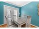 Dining area with a wood table and four chairs. Double doors provide access to the outside at 3710 W Tacon St, Tampa, FL 33629