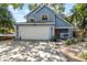 Charming blue two-story home featuring a wide driveway and attached two-car garage at 3710 W Tacon St, Tampa, FL 33629