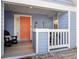 Charming covered front porch, adorned with dolphin art, and rocking chair at 3710 W Tacon St, Tampa, FL 33629