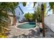 Outdoor pool area with tropical landscaping, blue skies, and a cozy patio setup at 3710 W Tacon St, Tampa, FL 33629