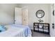 Cozy bedroom featuring a large clock and stylish shelving unit at 4396 Night Star Trl, Odessa, FL 33556