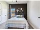 Well-lit bedroom featuring an accent wall, soft carpet, and closet at 4396 Night Star Trl, Odessa, FL 33556