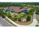 Aerial view of a school and surrounding grounds featuring playground, outdoor recreation area, and parking at 4396 Night Star Trl, Odessa, FL 33556