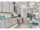 A gourmet kitchen features gray cabinets, granite countertops, stainless steel appliances, and a stylish island at 4396 Night Star Trl, Odessa, FL 33556