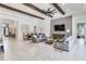 Spacious living room boasts decorative ceiling beams, tile flooring, and an open layout at 4396 Night Star Trl, Odessa, FL 33556