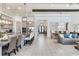 Bright, open concept living area with marble floors and modern lighting flowing into the kitchen and dining room at 4396 Night Star Trl, Odessa, FL 33556