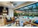 Cozy outdoor seating area with a fully equipped kitchen and views of the screened-in pool at 4396 Night Star Trl, Odessa, FL 33556