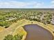 Expansive aerial view of a lush golf course community featuring a scenic lake and mature trees at 4419 Swift Cir, Valrico, FL 33596