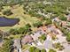 Aerial view of a home with solar panels, a pool, and mature landscaping in a golf community at 4419 Swift Cir, Valrico, FL 33596