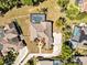 Aerial view of backyard featuring a screened pool, lush lawn, and manicured landscaping at 4419 Swift Cir, Valrico, FL 33596